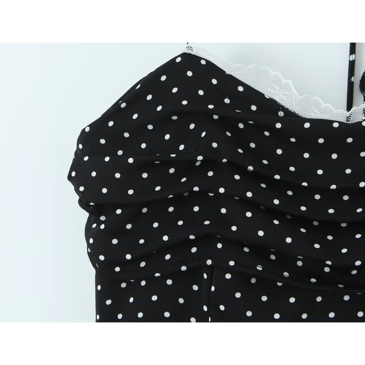 Close-up of the ruched bodice and scalloped lace trim at the bust line