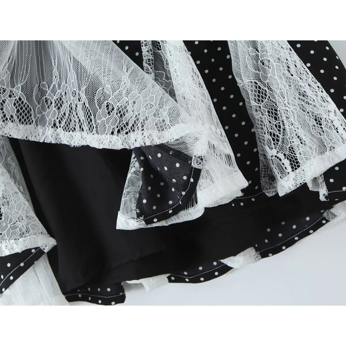 Close-up of the tiered lace panels at the skirt hem, showing the delicate texture.
