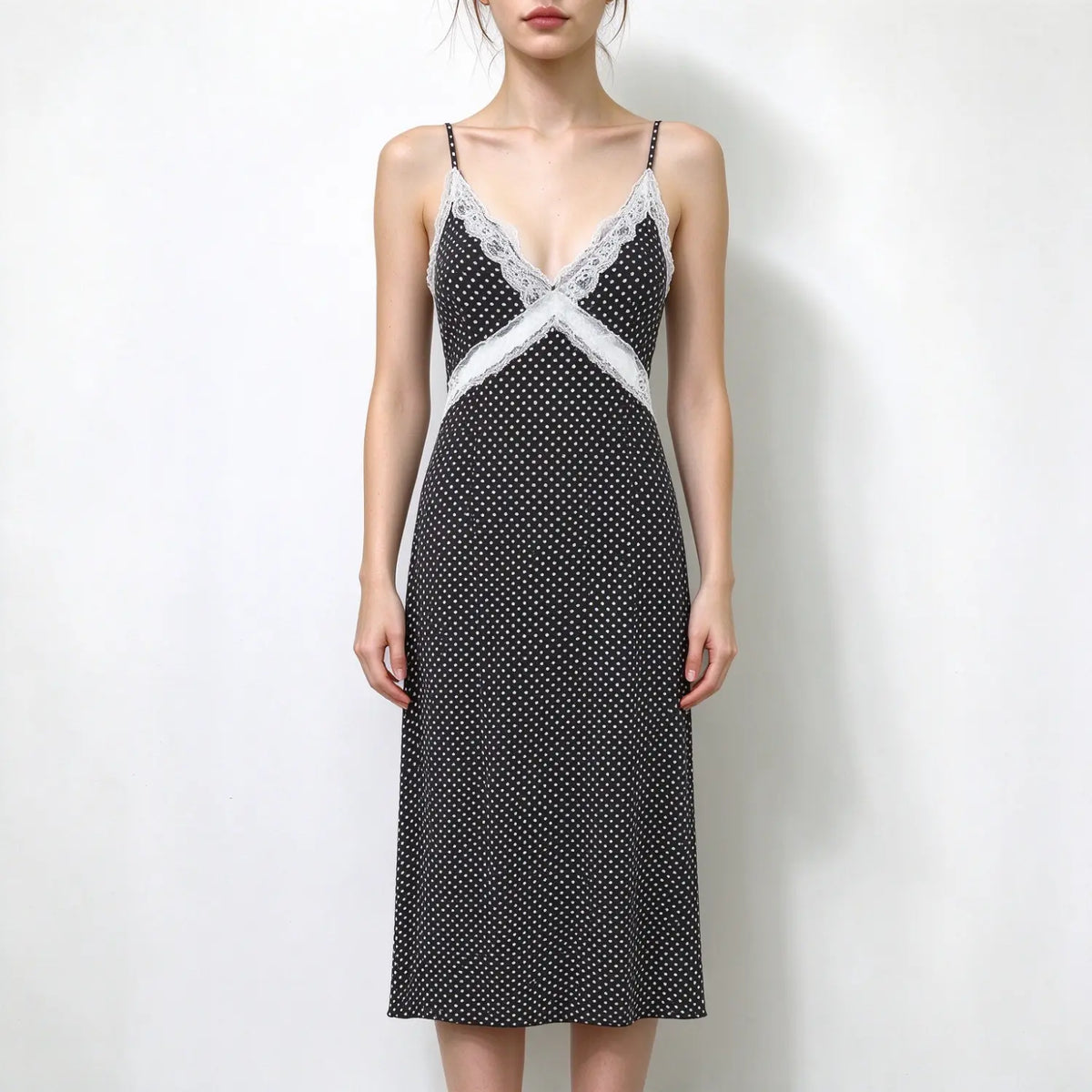 Model in black white polka dot slip maxi dress, v neck trimmed with white lace, thin spaghetti straps, fitted maxi skirt
