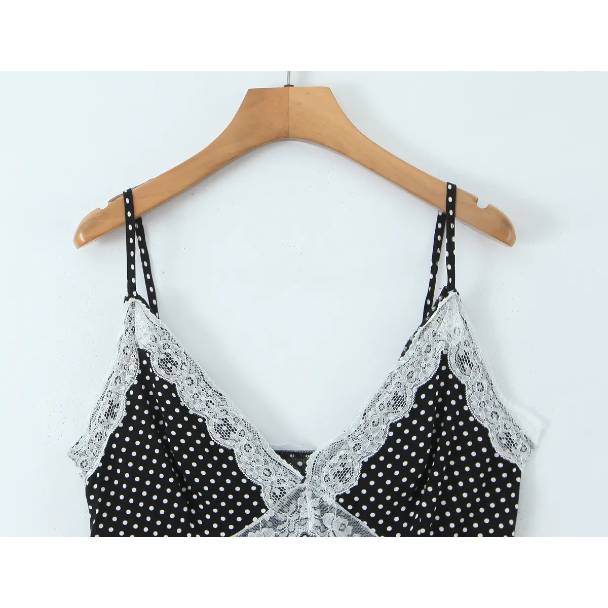 Close-up of the double spaghetti straps and the delicate lace trim along the V-neckline.