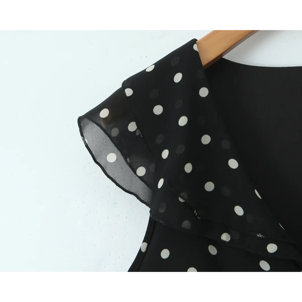 Close-up of the layered chiffon ruffle at the armhole/shoulder.