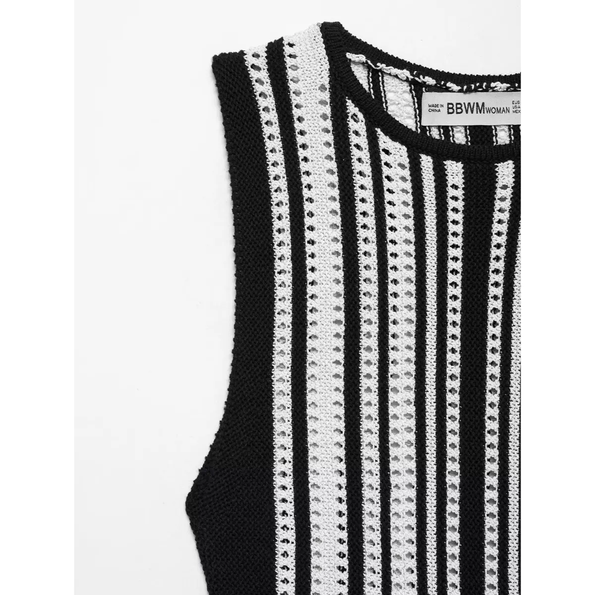 Close-up detail shot of the front neckline and upper bodice on a black and white striped knit mini dress, showing the openwork pattern.