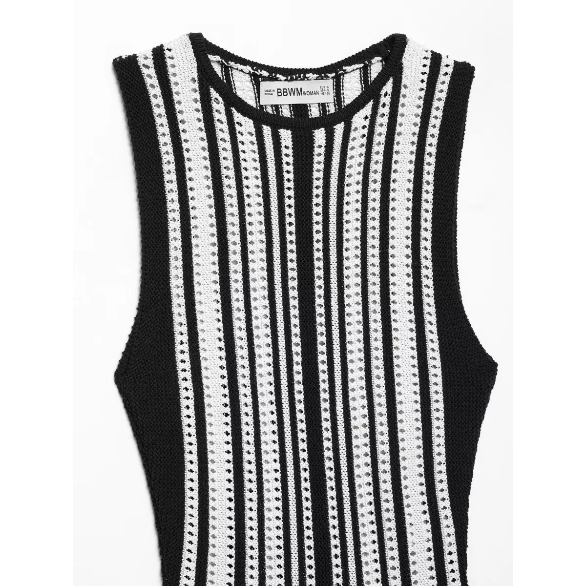  Full front flat view of a black and white striped knit mini dress, displaying the vertical stripes, round neckline, and ruffled hem.