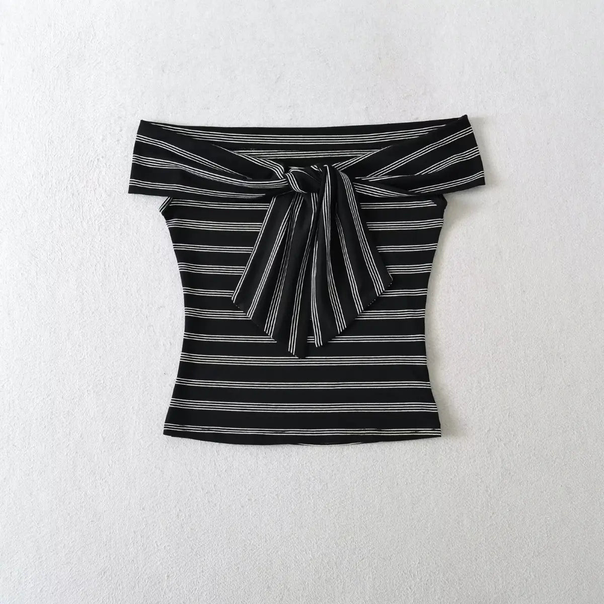 Front shot of the black and white striped off-shoulder top, with the central tie detail visible.