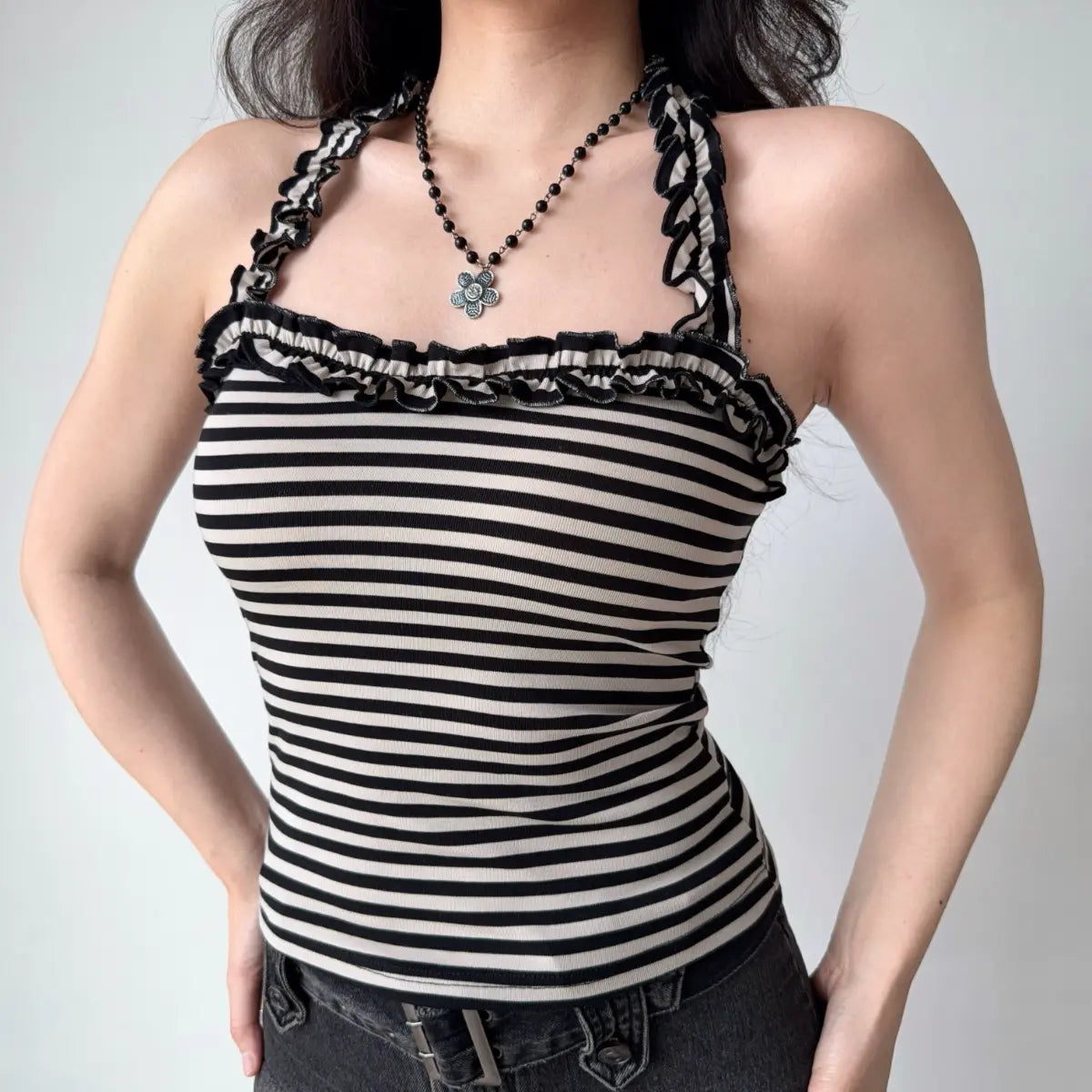 The complete outfit, featuring the striped halter top and black denim mini skirt.