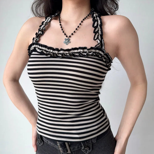 The complete outfit, featuring the striped halter top and black denim mini skirt.