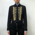Model wearing front view black cropped military blazer with gold braid embroidery