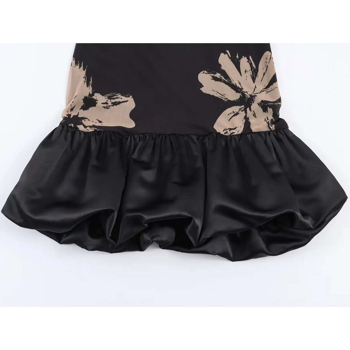 Close‑up satin ruffle hem of black floral mesh mini dress,gathered frill bottom