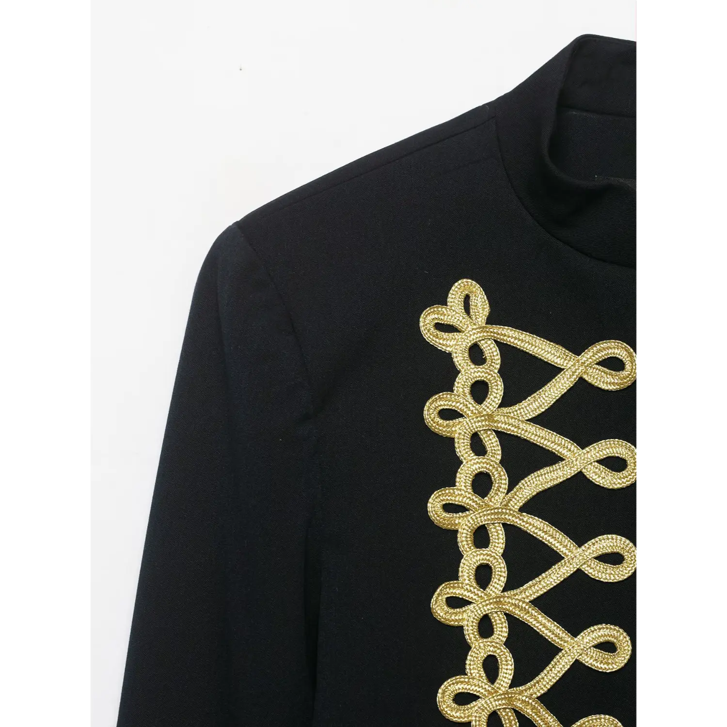 Close‑up shoulder and gold braid embroidery detail of black military blazer
