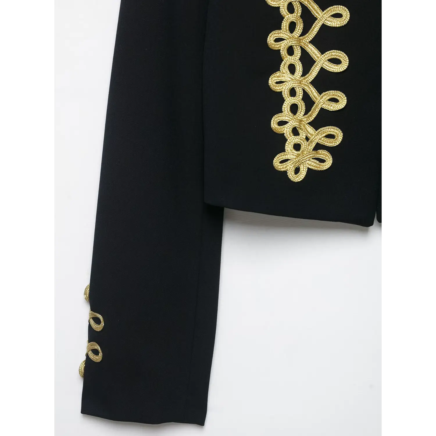 Sleeve cuff close‑up with gold braid embroidery on black cropped blazer