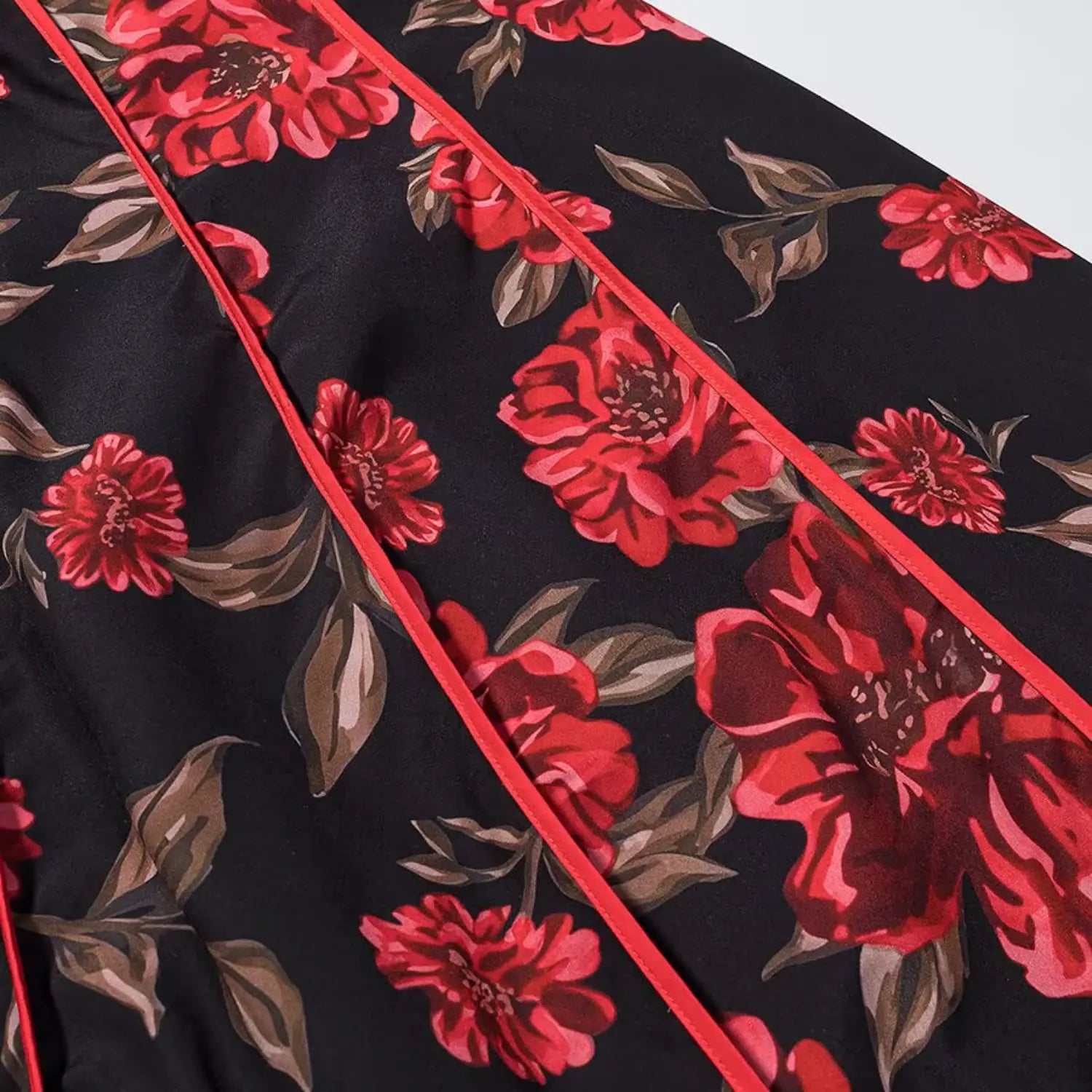 Close‑up of front panel red piping and floral print