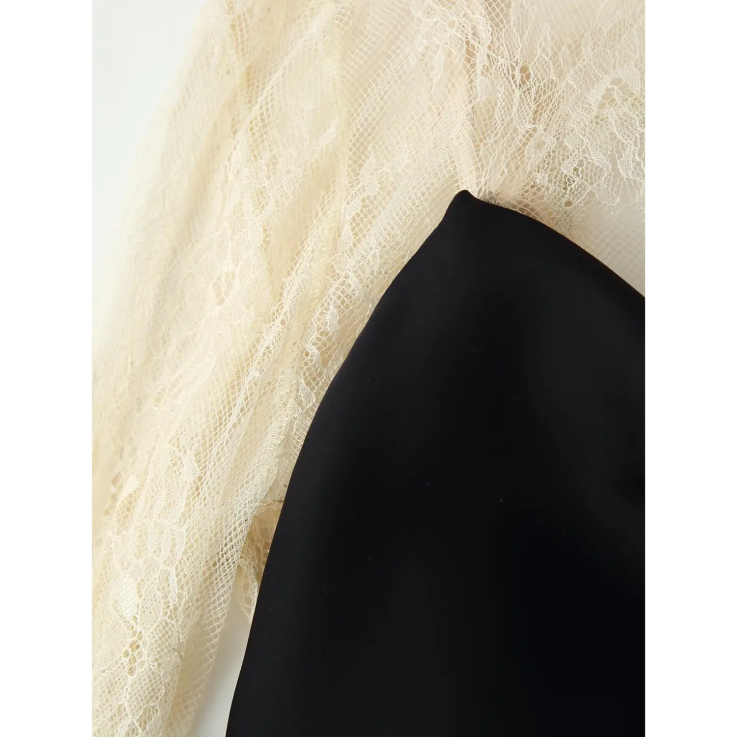 Fabric detail shot, smooth black satin slip dress combined with sheer cream floral lace overlay panel