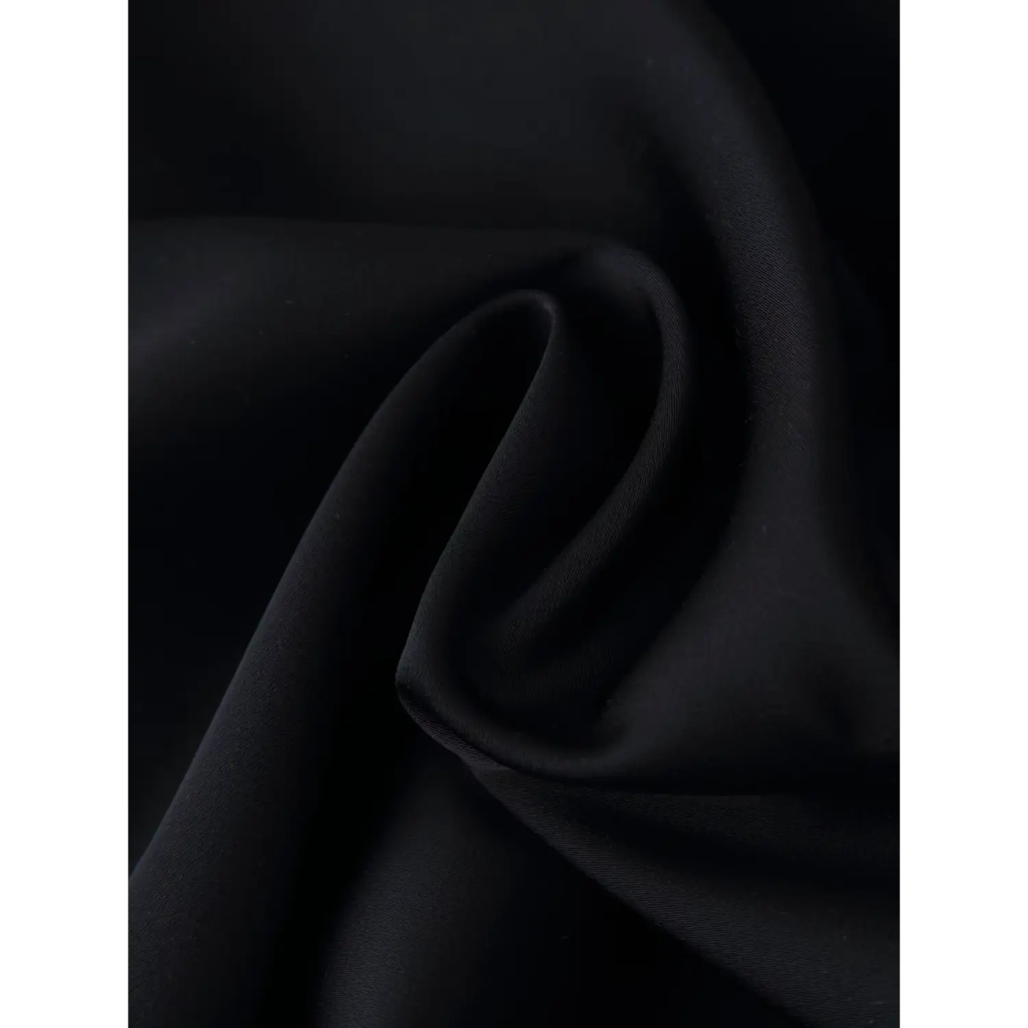 Close‑up texture shot of smooth glossy black satin fabric for slip mini dress