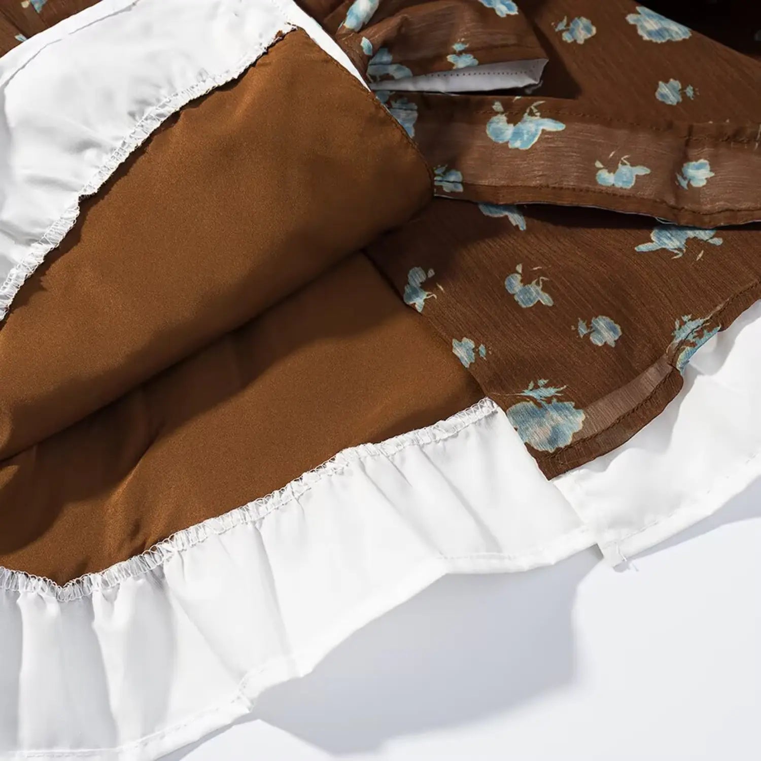Blouse hem detail, detachable white chiffon ruffle underlayer, neat serged edge stitching