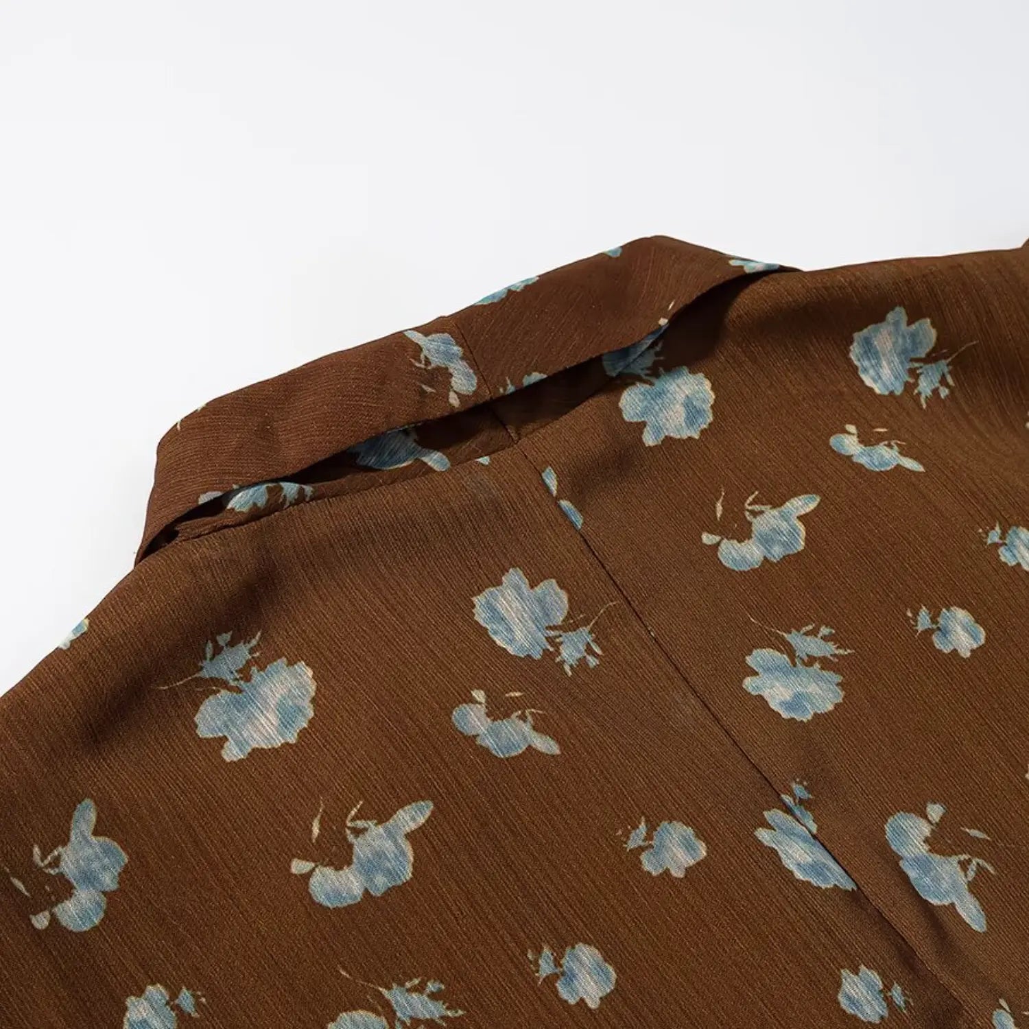 Front V neck stand collar partial shot, wrinkled chiffon fabric with scattered light blue flower print