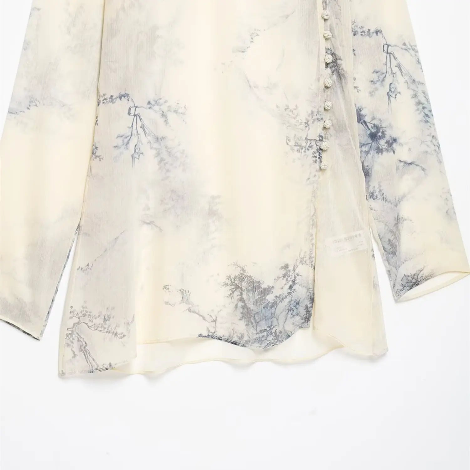 Side hem partial shot, full ink landscape print fabric, inner woven size label, irregular curved bottom hem