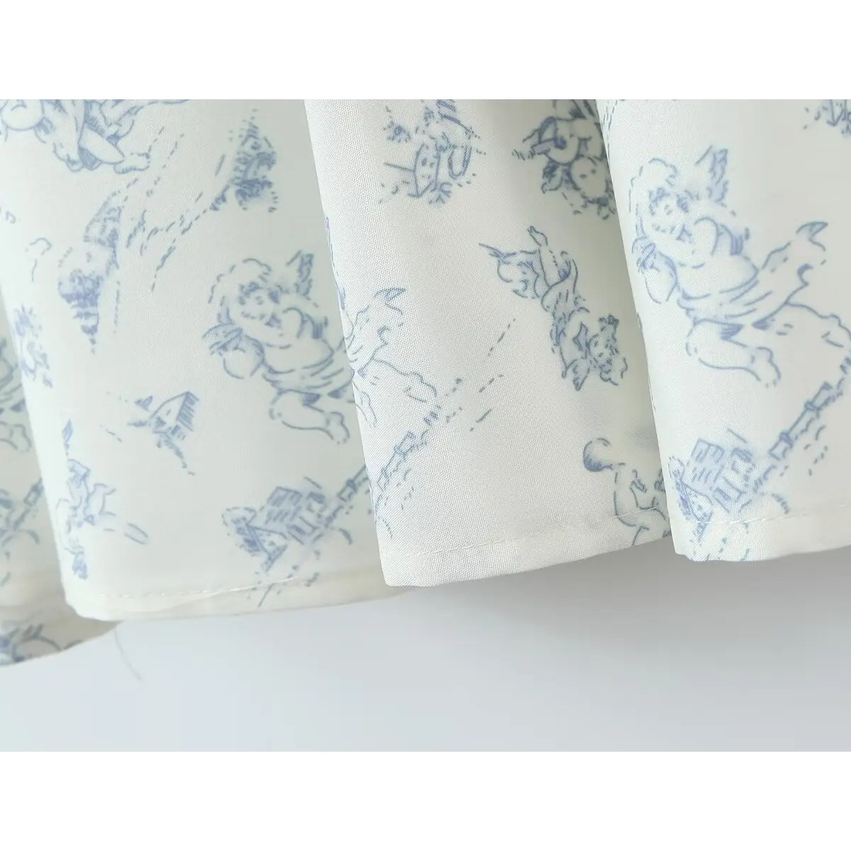Close-up of the tiered skirt hem, showing the finished stitching and blue angel print.