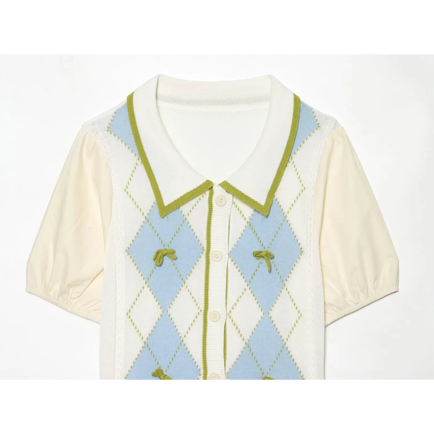 Partial front shot of white collared knit blouse, light blue argyle jacquard with green piping, handmade mini green bow decor, mixed fabric bubble short sleeves, preppy sweet top
