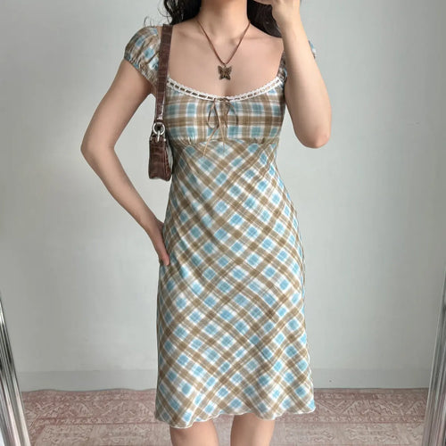 Front view of a blue and brown plaid midi dress with lace trim and puff sleeves.
