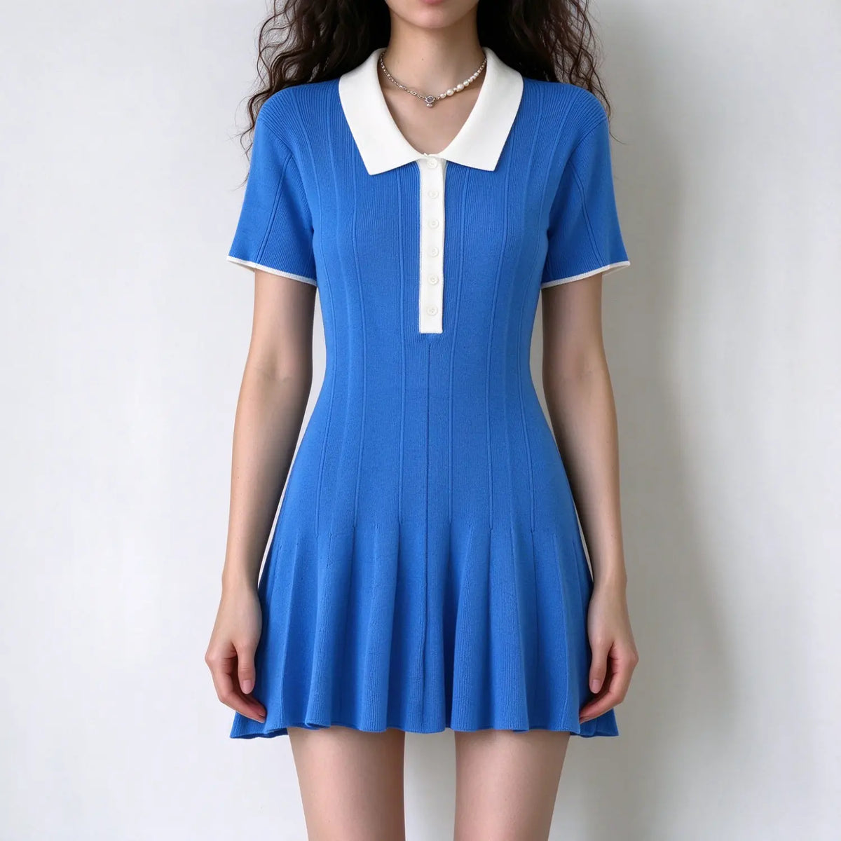 Model wearing blue contrast collar ribbed knit polo mini dress, front view