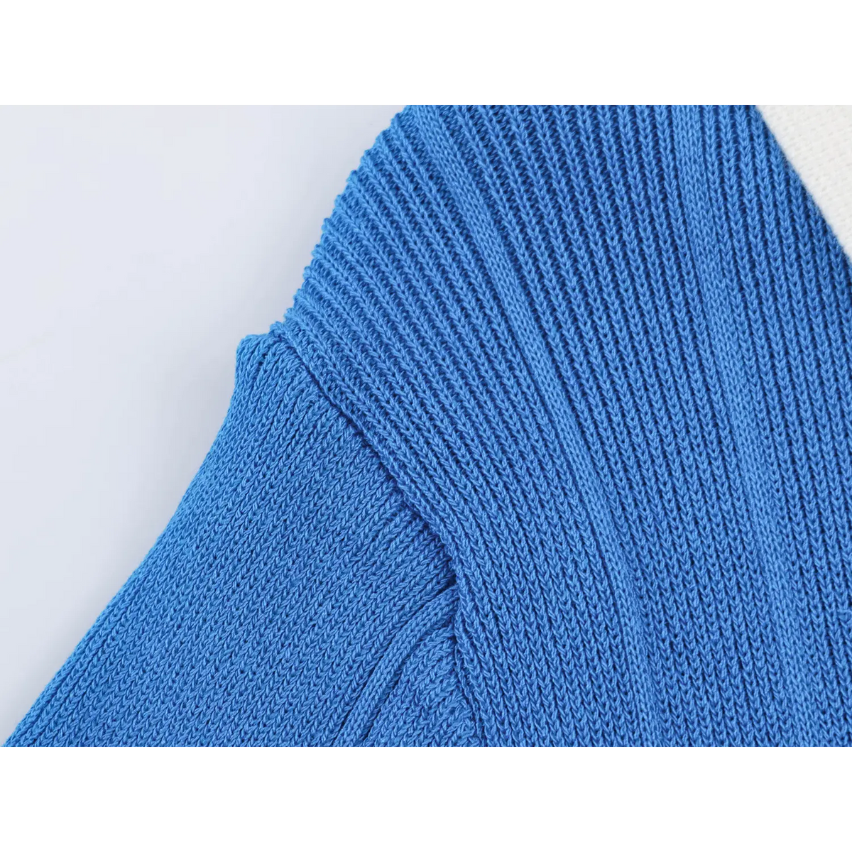 Close-up of shoulder seam and ribbed knit