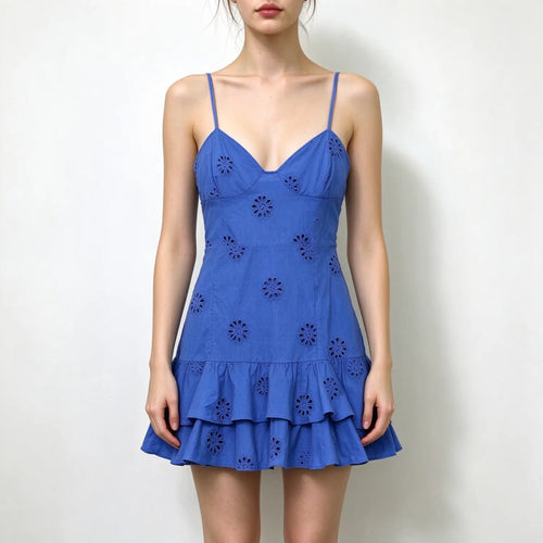 Model wearing blue eyelet lace spaghetti strap mini dress with v neck and double ruffle hem, plain white background