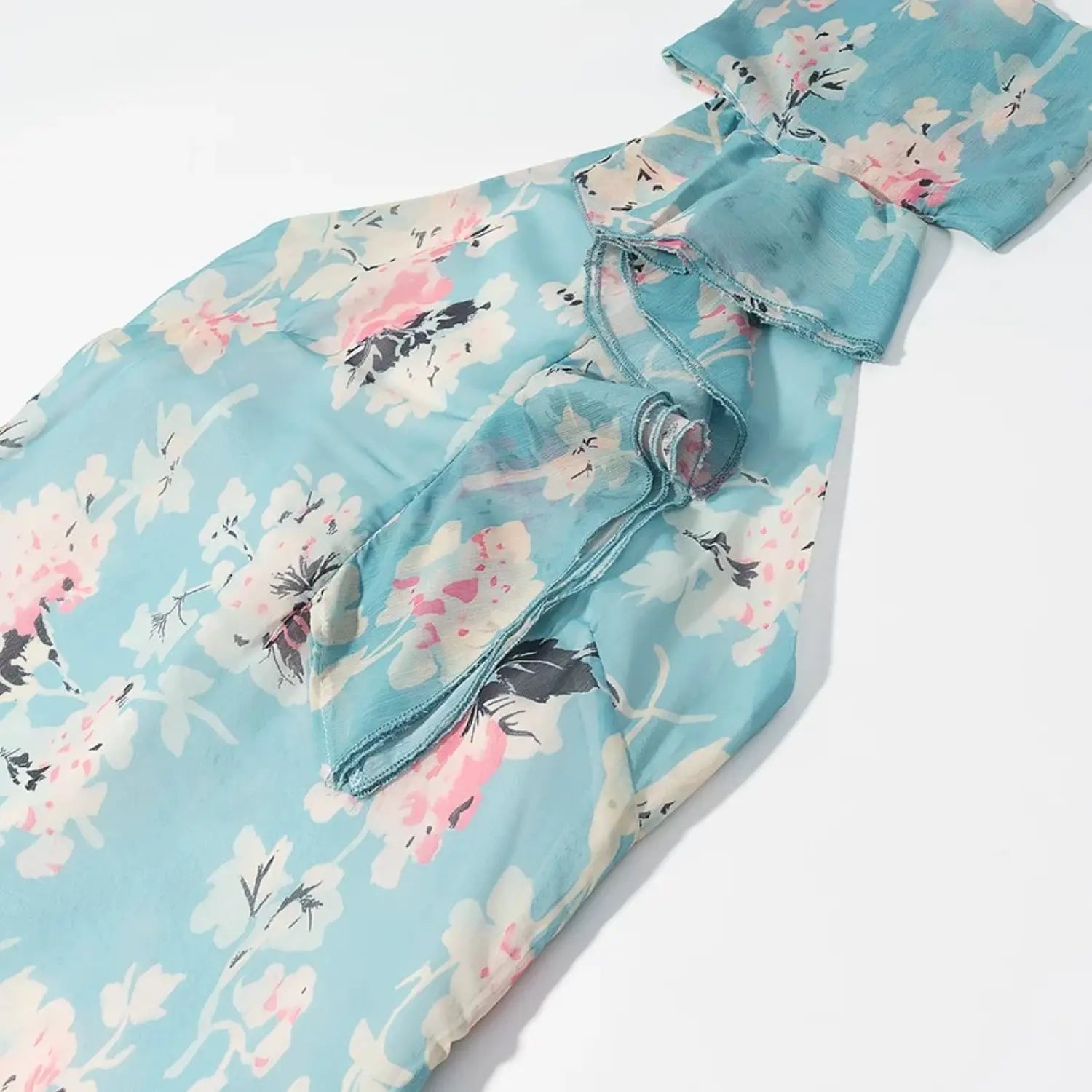 Partial shot of upper body, flowy sheer blue floral chiffon, ruffled halter neck design