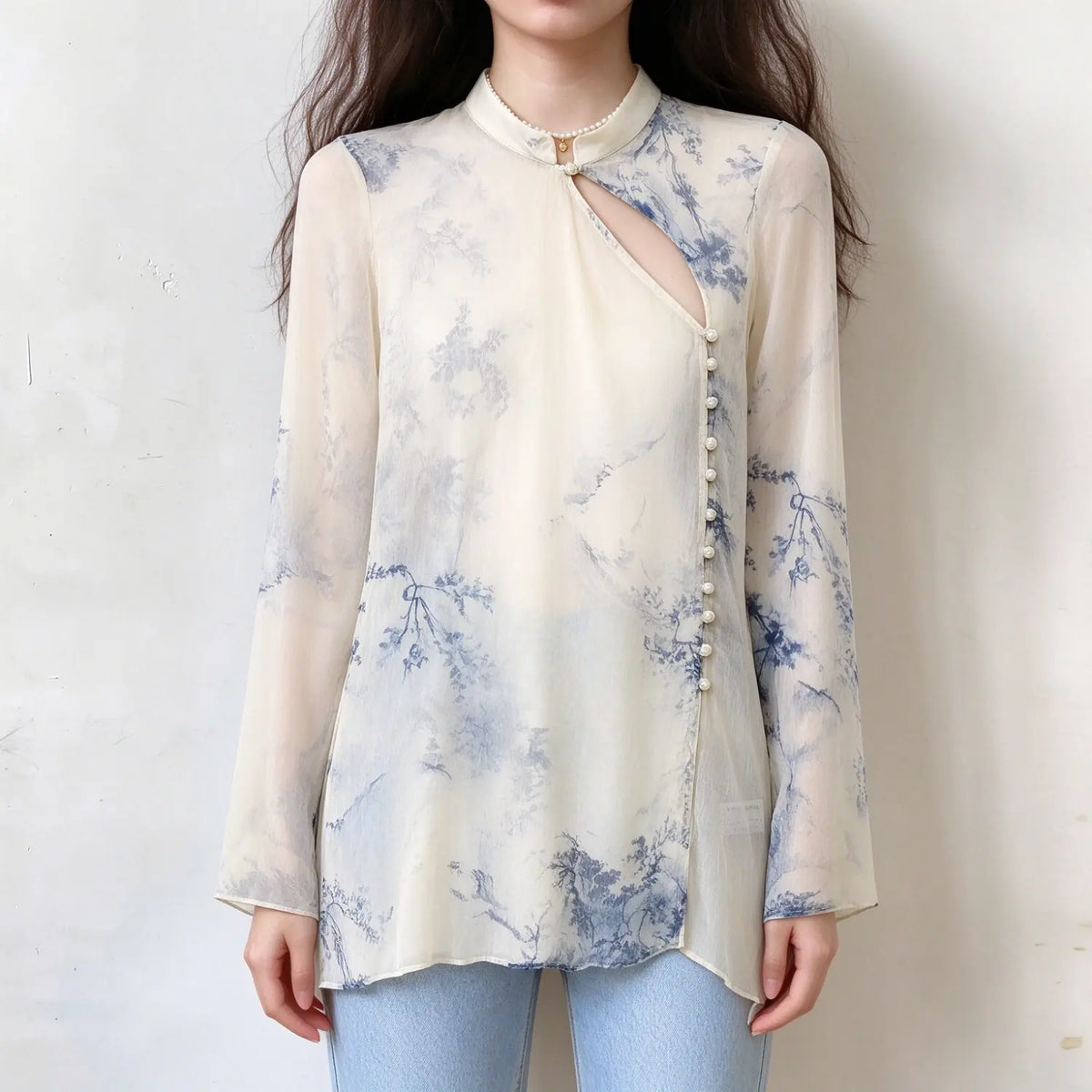 Model wearing cream chiffon new chinese style blouse with blue floral print, stand collar, cutout chest, pearl button placket, long flared sleeves