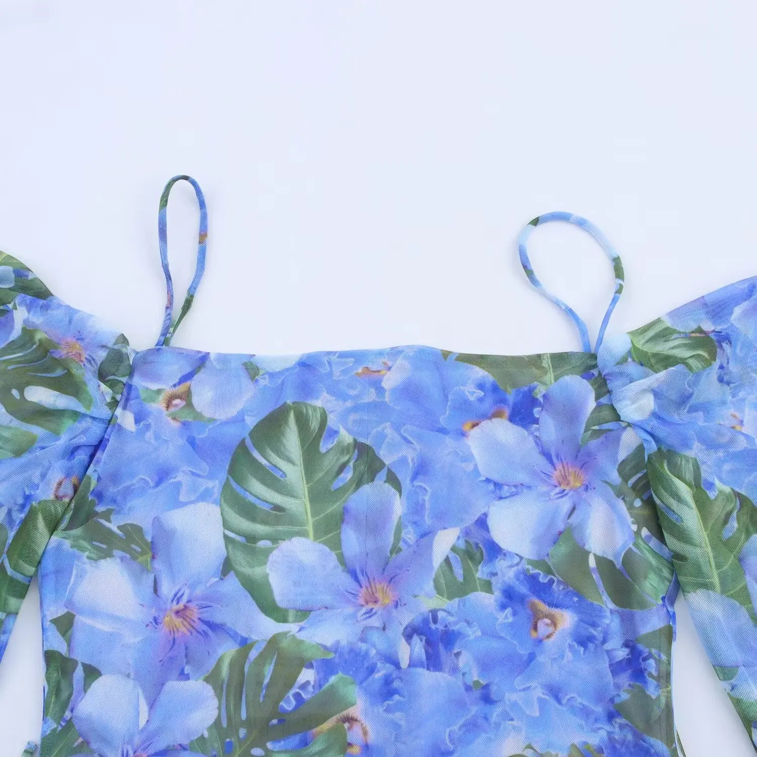Close‑up view of bodice and thin spaghetti straps on blue tropical floral off‑shoulder mesh mini dress