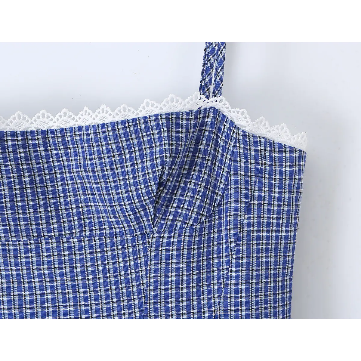 Close-up of the lace-trimmed neckline and gingham fabric on the blue cami dress