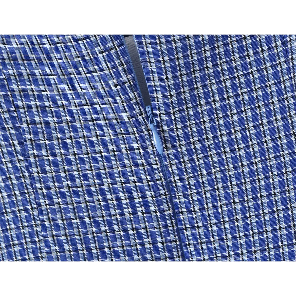 Close-up of the side zipper closure and gingham fabric texture on the blue tiered dress