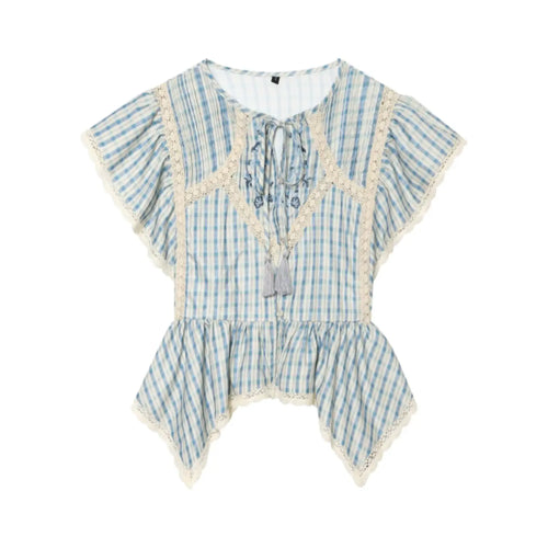 Studio white background full front shot of blue gingham peplum blouse, keyhole neck with tassel tie, floral embroidery, hollow lace panels, flutter cap sleeves, asymmetrical handkerchief hem