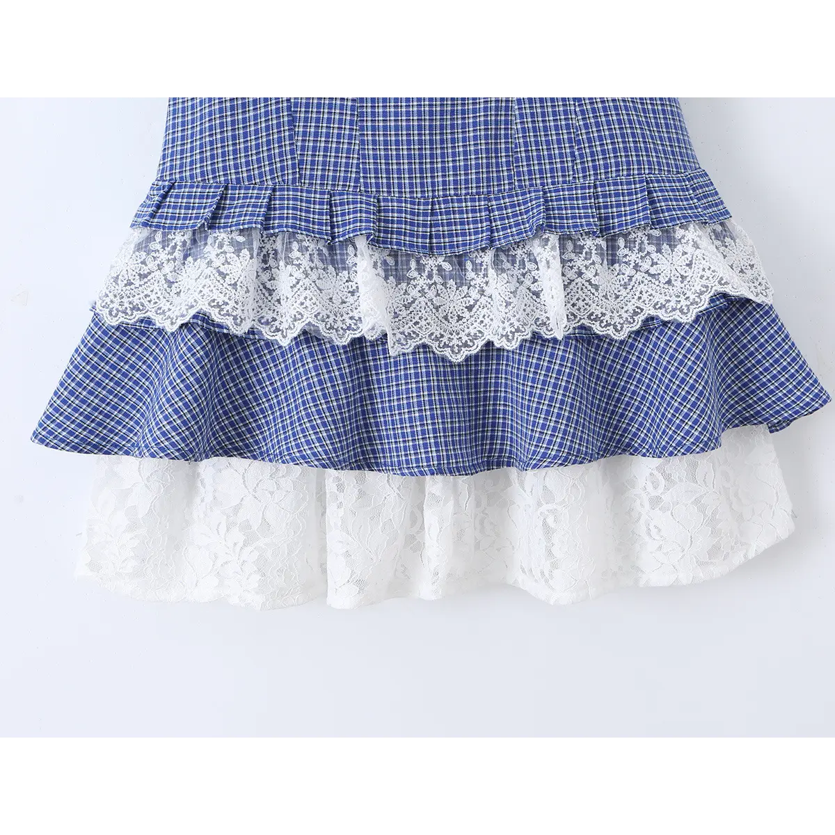 Full view of the layered tiered skirt with lace trim on the blue gingham cami dress