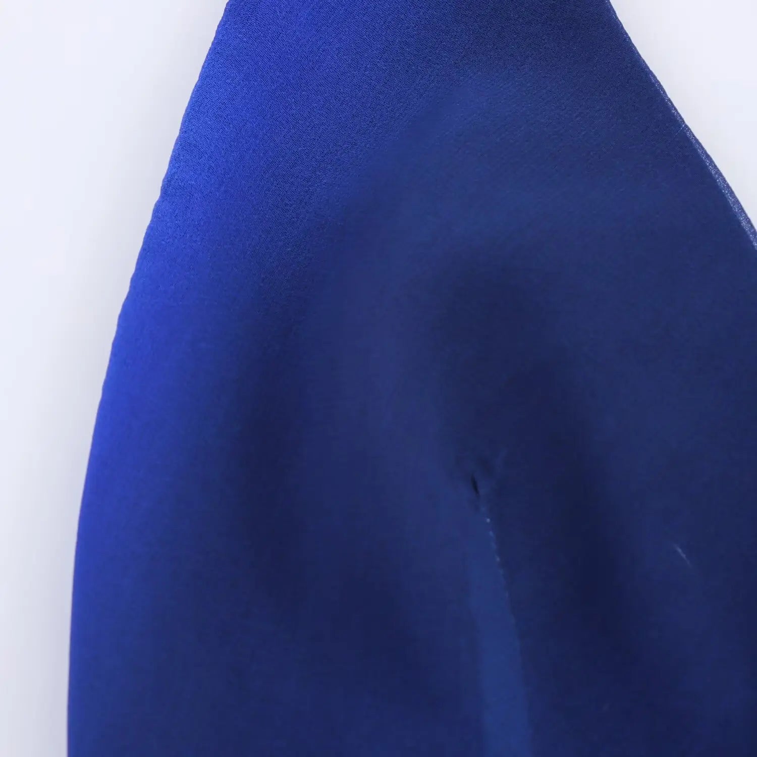 Macro close‑up of blue gradient chiffon fabric, soft flowing texture, abstract swirl print