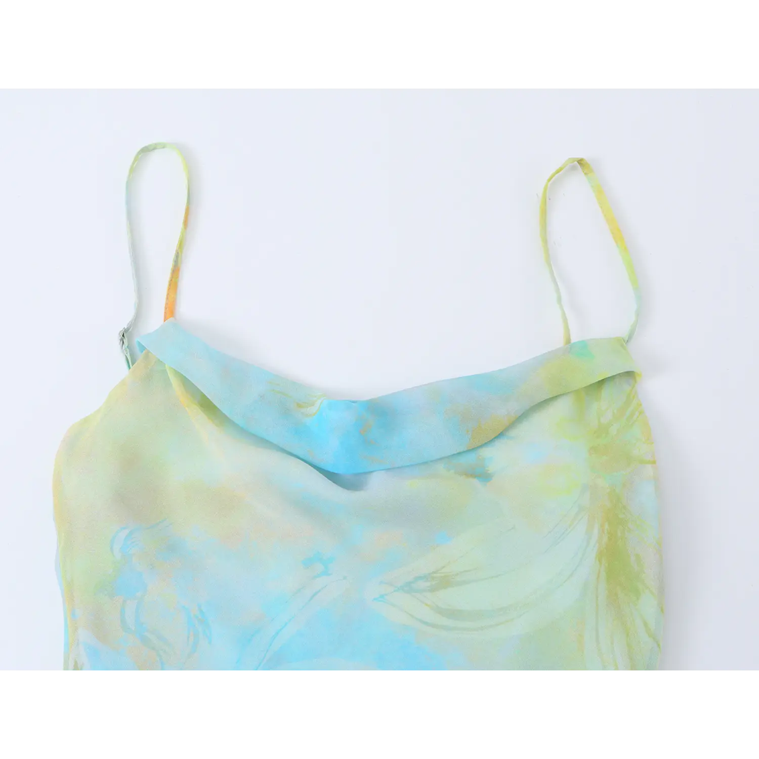 Close-up of cowl neckline and adjustable spaghetti straps on blue green watercolor floral slip dress