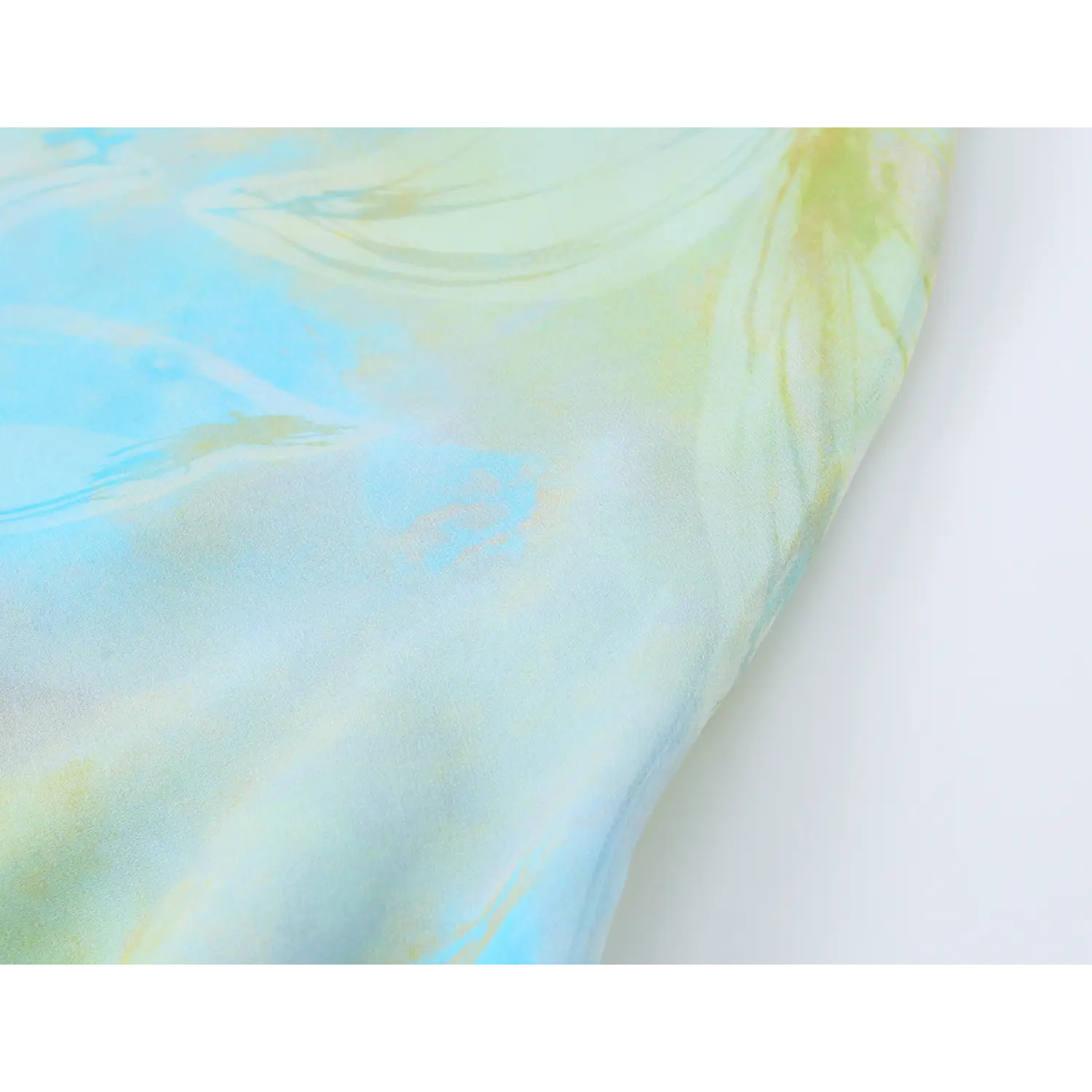 Close-up of watercolor floral print fabric on blue green slip midi dress