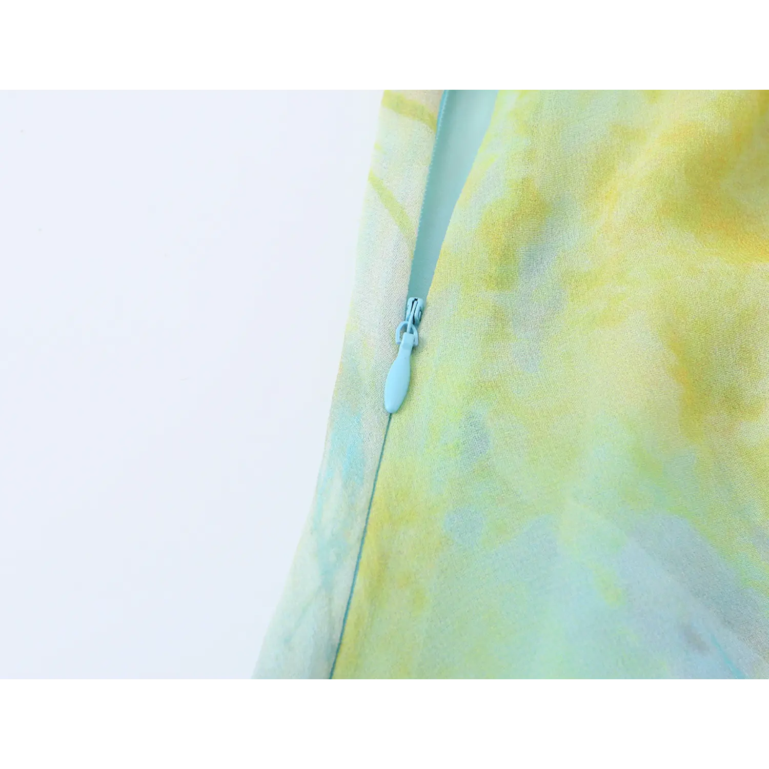 Close-up shot of side invisible zipper on blue green watercolor floral slip midi dress