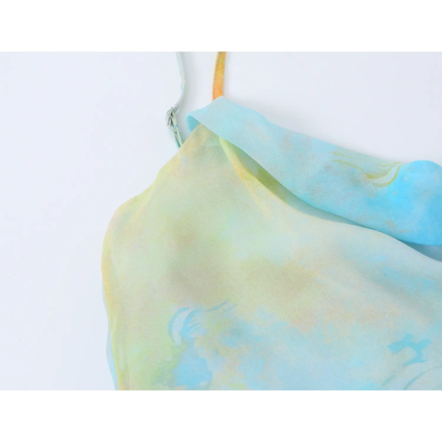 Close-up detail of adjustable slider on thin spaghetti strap of watercolor floral slip midi dress