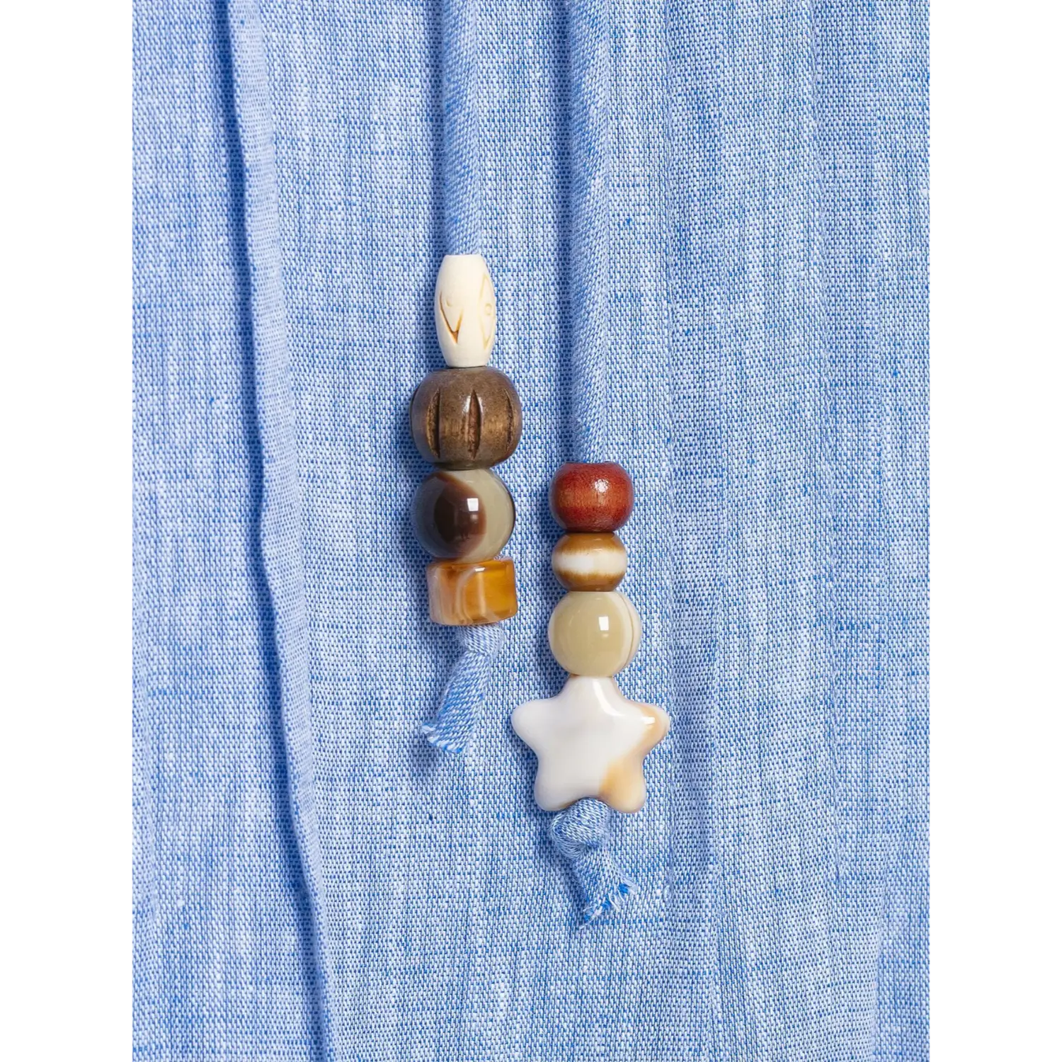 Extreme close‑up mixed wood stone star‑shape bead tassel ornament for dress neck tie