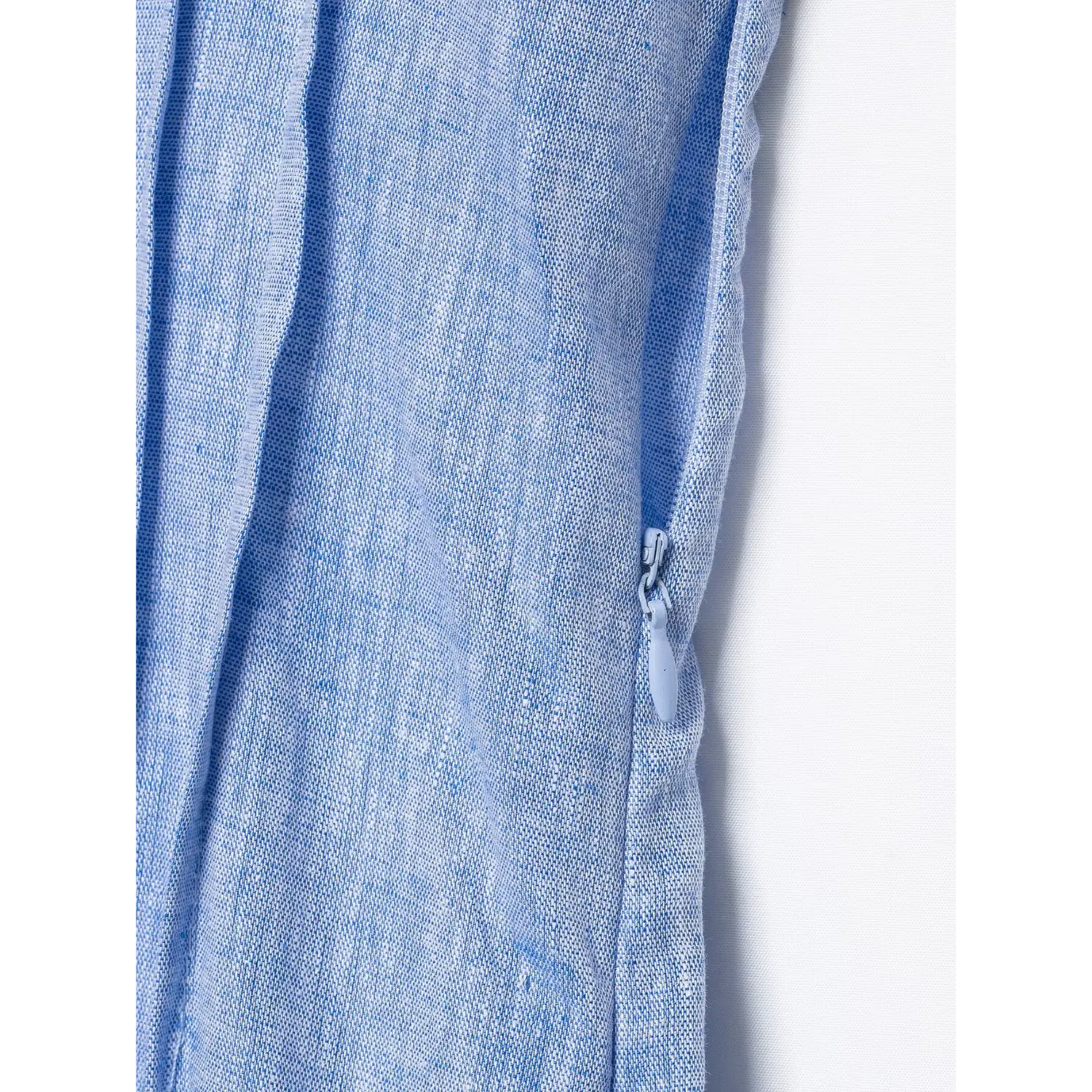 Macro detail shot side invisible zipper workmanship on blue linen maxi dress
