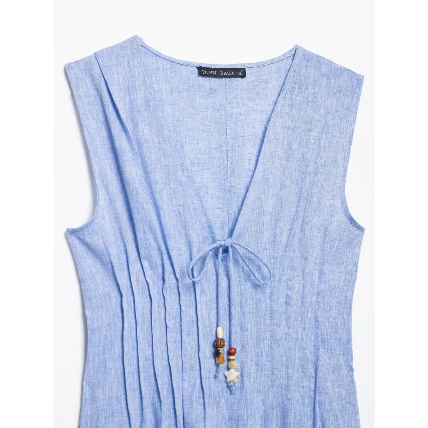 Close‑up upper part blue linen maxi dress, v‑neck tie drawstring and mixed wood bead tassel ornament