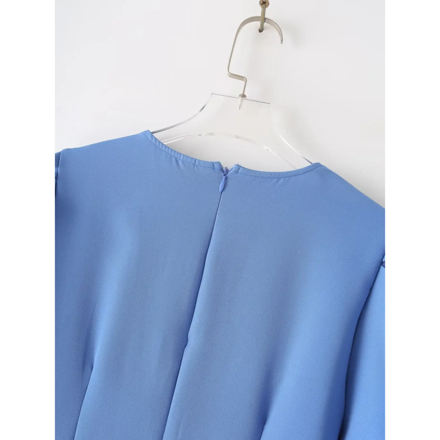 Hanging back view blue mini dress, round neck, center back invisible zipper and clean back seam lines