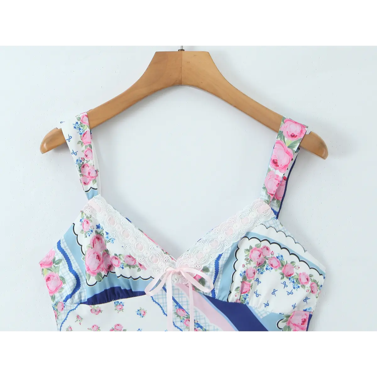 Close-up front view of the bust and bow detail on the scarf print dress.