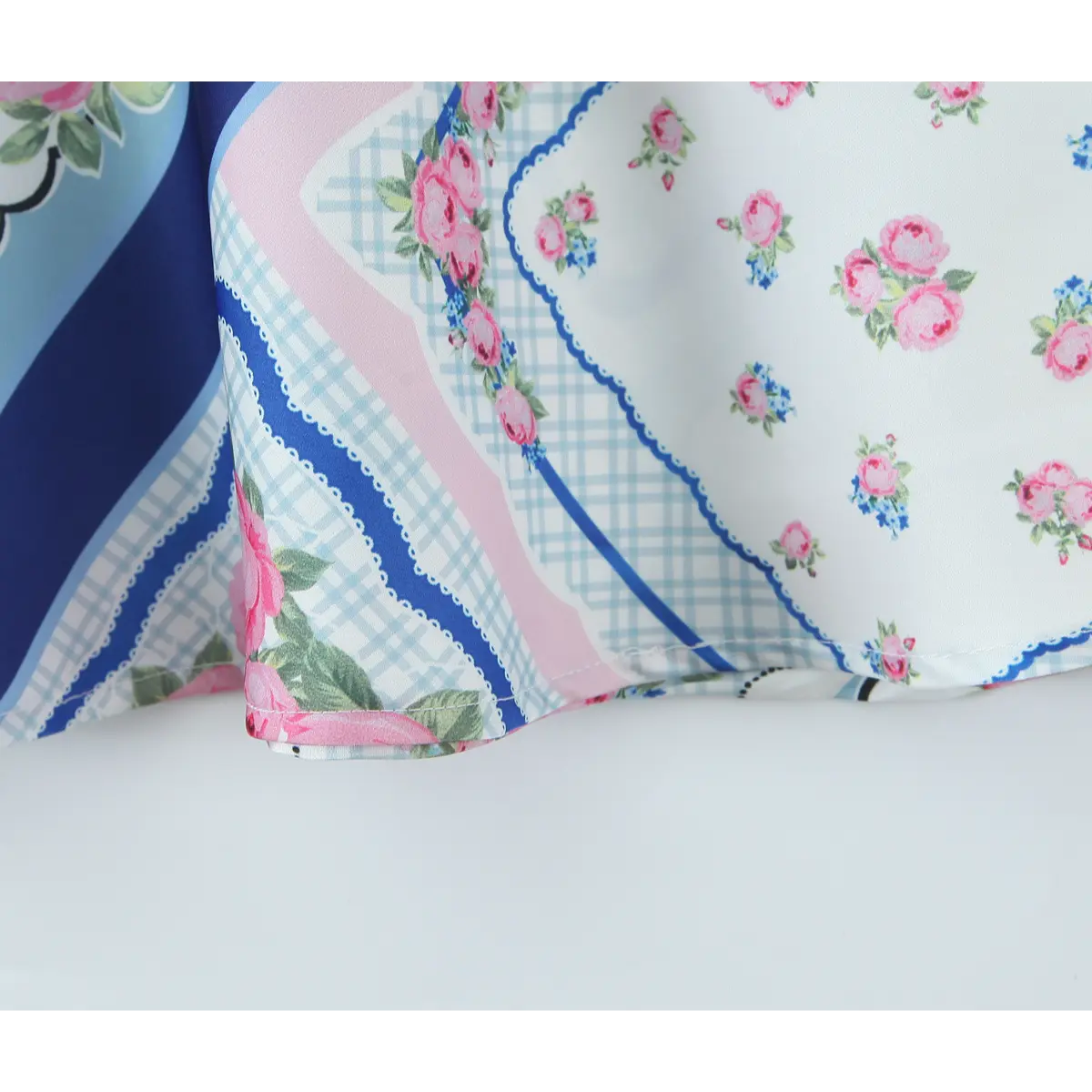  Close-up of the scarf-style floral print and fabric texture on the dress.