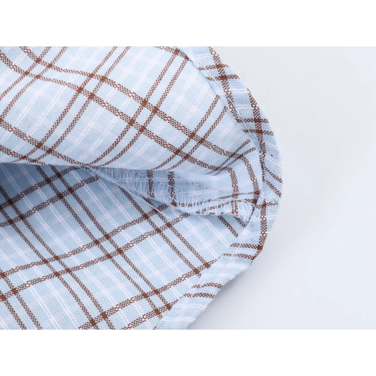 Close-up of the dress's hem, showing the finished seam and the fabric's reverse side.