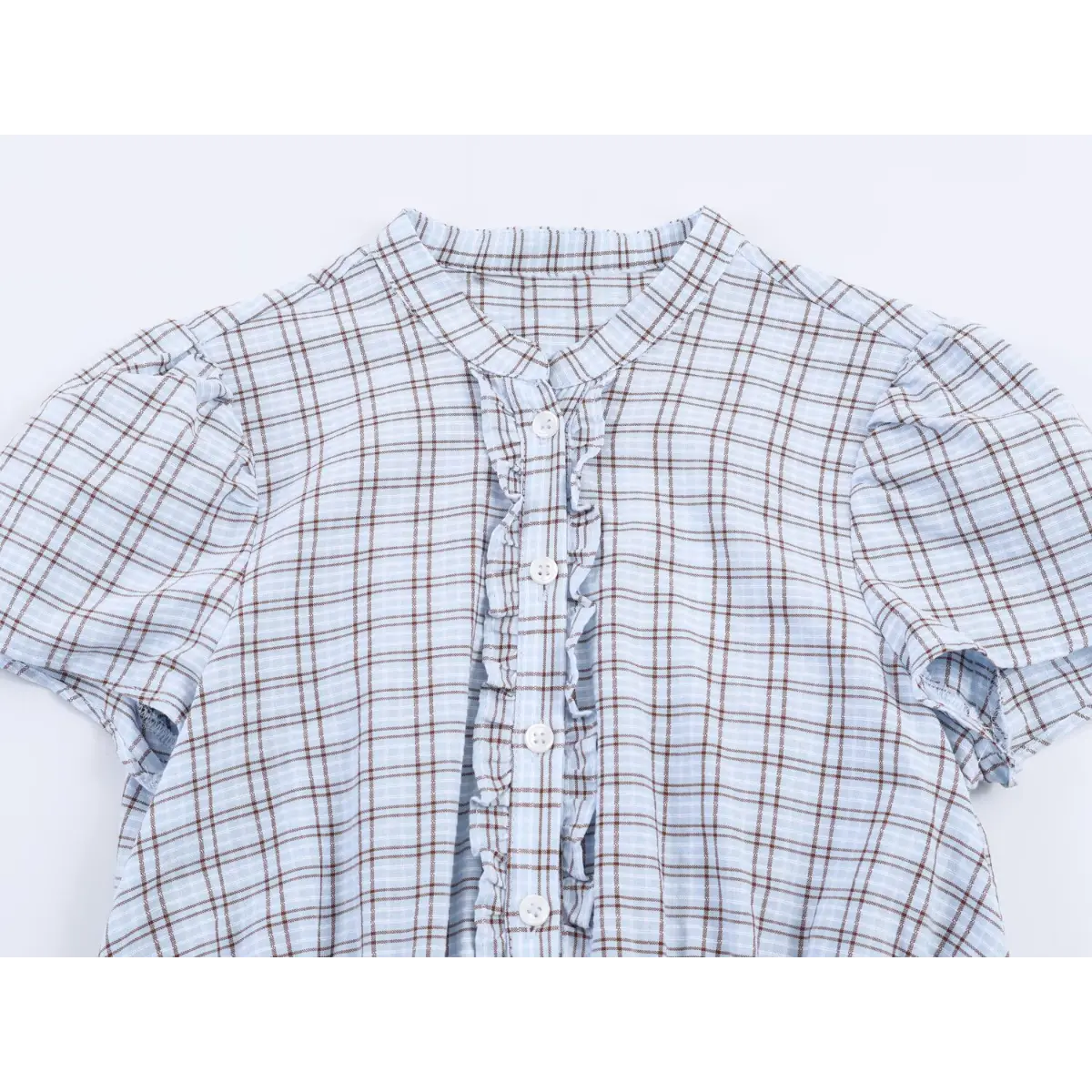Top view of the dress's mandarin collar, button placket with ruffles, and puff sleeves.