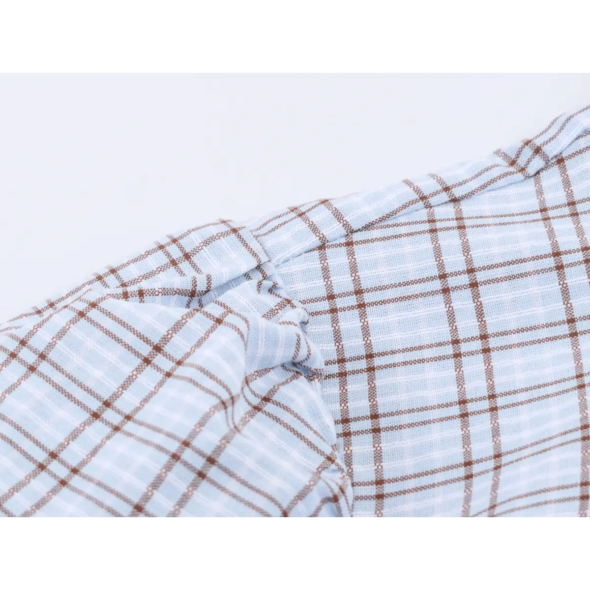 Close-up of the dress's puff sleeve, showing the gathered construction and plaid fabric.