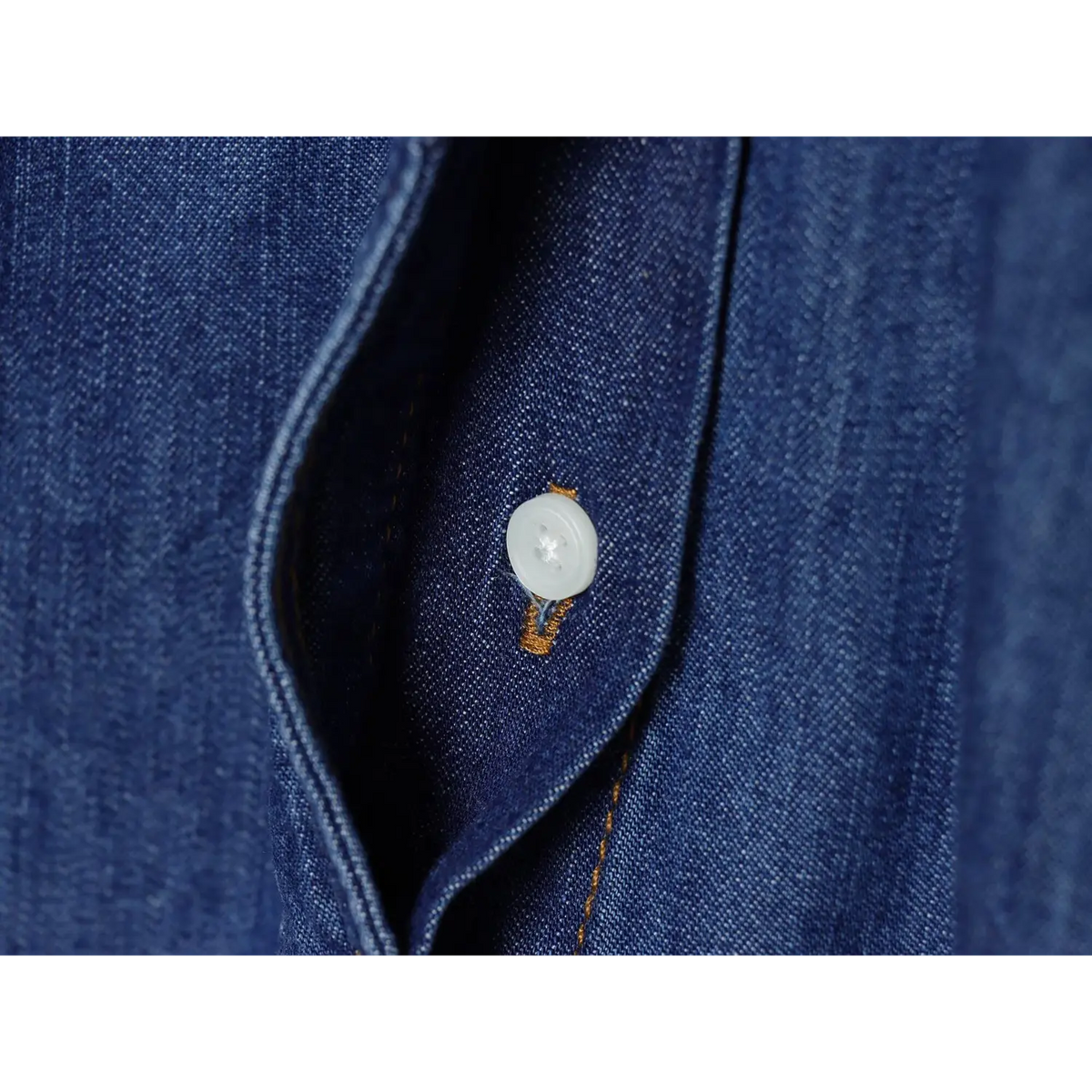 Close-up of white shirt button on front placket