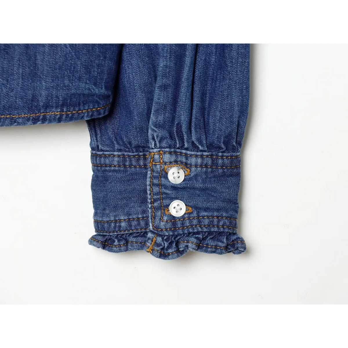 Close-up of double-button ruffled cuff