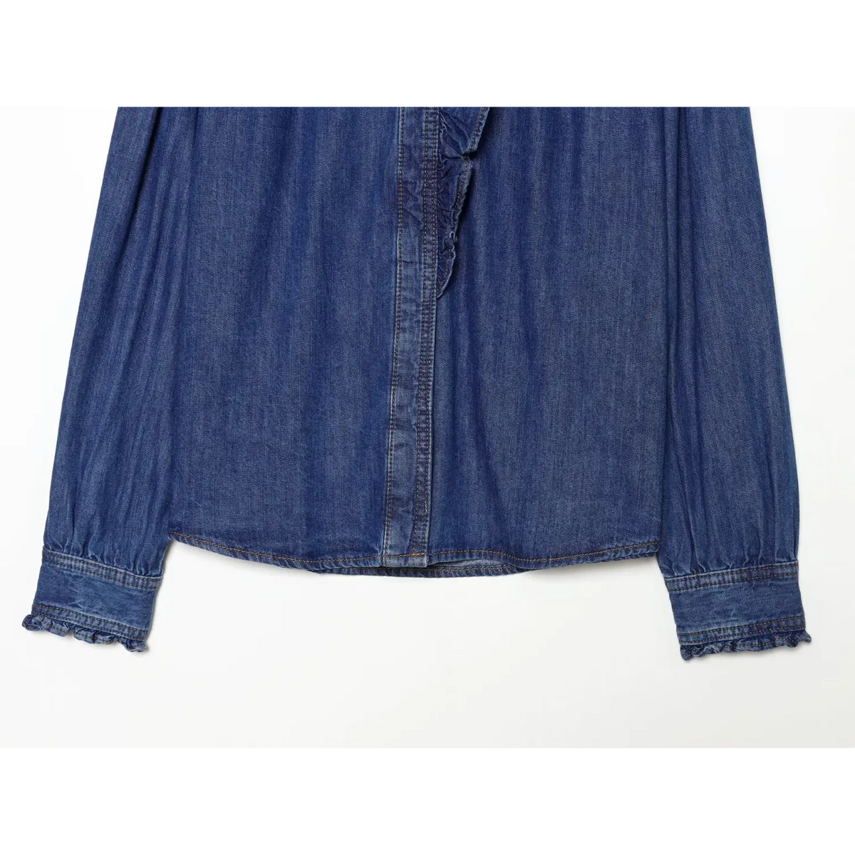 Close-up of curved hem and ruffled cuffs